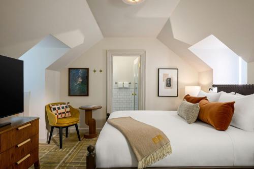 a bedroom with a large bed and a television at Dearborn Inn, Autograph Collection in Dearborn