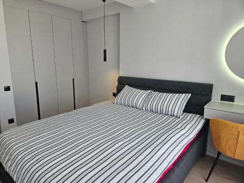 a small bedroom with a bed with a black headboard at ZEN home in Chişinău