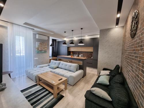 a living room with a couch and a table at Diplomat Lev Tolstoi 74 street Apartments in Chişinău