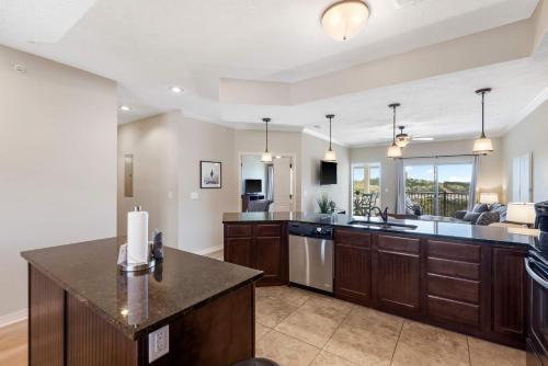 a kitchen with wooden cabinets and a counter top at Table Rock Overlook - Spend your Days on the Lake in Branson