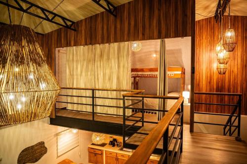 a room with a staircase and a chandelier at The Brown House in Oaxaca City