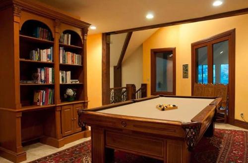 a room with a pool table and a book shelf at Luxurious Mountain Retreat with Pool Midway in Mound City