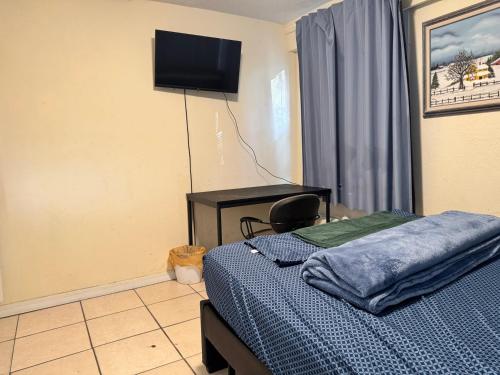 a bedroom with a bed and a desk and a television at Tampa Downtown property in Tampa