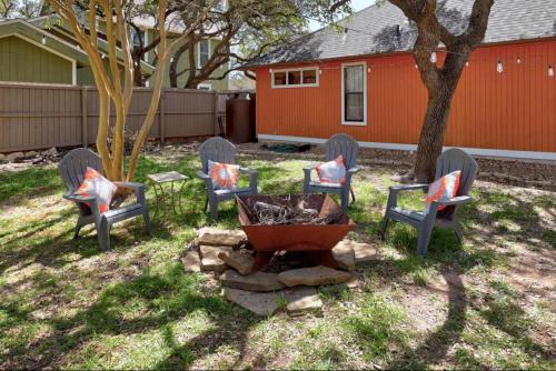 a group of chairs sitting around a fire pit in a yard at Lake Travis Retreat with Spacious Outdoor Areas in Austin
