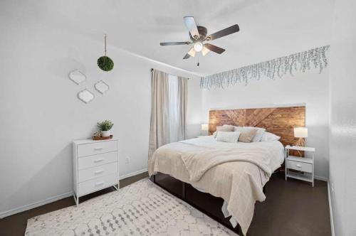a white bedroom with a bed and a ceiling fan at Lake Travis Retreat with Spacious Outdoor Areas in Austin