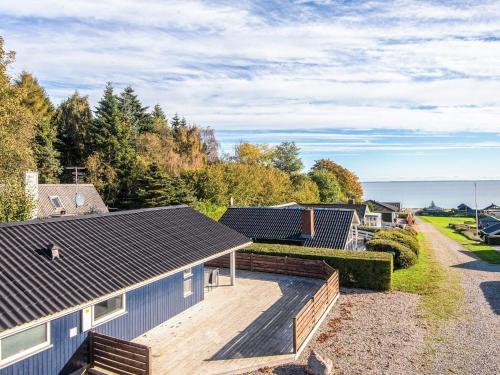 an aerial view of a house with a wooden deck at Seaside Haven with open terrace in Sønder Bjert