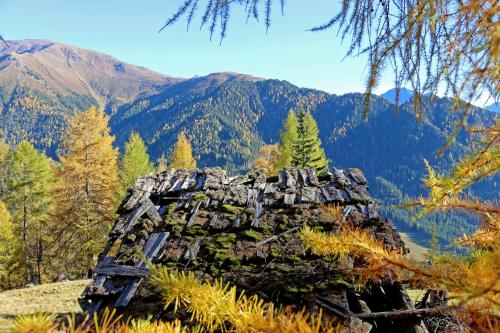 a rock formation on a hill with mountains in the background at Pension Fuchs in Pfunds