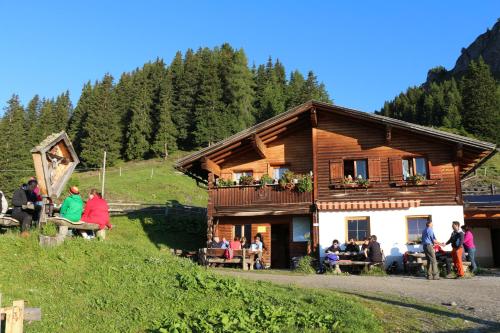 a group of people sitting outside of a building at Pension Fuchs in Pfunds