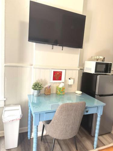 a blue table with two chairs and a microwave at Cozy nest private porch museums free parking in Richmond