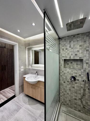 a bathroom with a sink and a shower at the luxury apartment in Madinaty