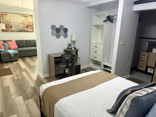 a bedroom with a bed and a desk and a couch at Tree of life in Temple