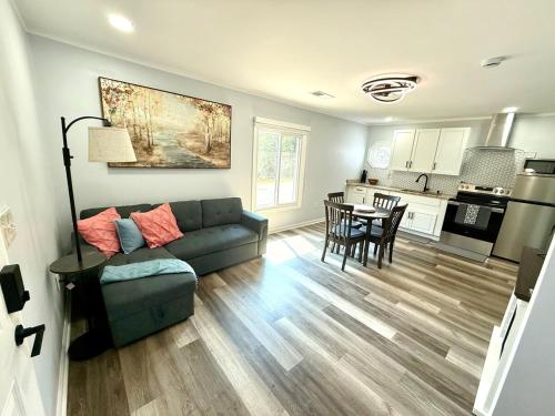 a living room with a couch and a kitchen at Tree of life in Temple