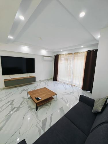 a living room with a couch and a flat screen tv at Large Deluxe Apartment in St. Paul's Bay