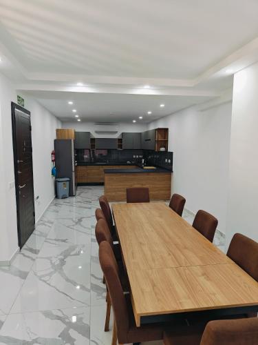 a conference room with a wooden table and chairs at Large Deluxe Apartment in St. Paul's Bay