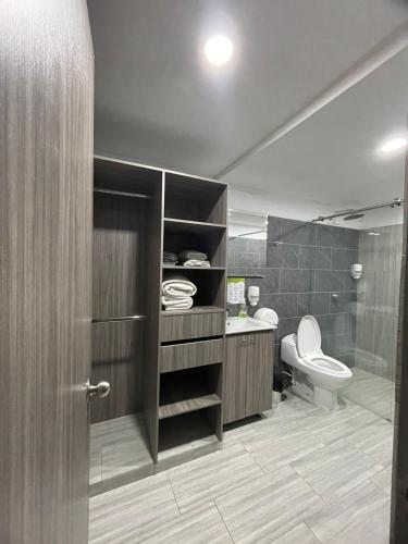 a bathroom with a toilet and a sink and a shower at ZOI Eco Hotel y Glamping in Manizales