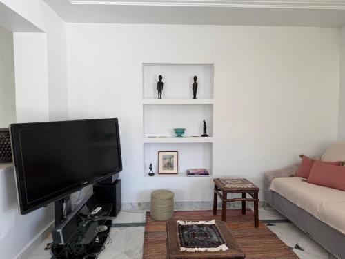 a living room with a large flat screen tv at Casaflor Tunis in Berges Du Lac