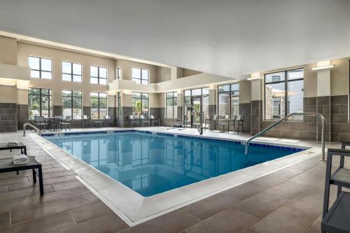 a large swimming pool with blue water in a building at Residence Inn Richmond Airport in Sandston