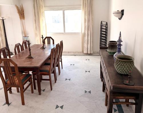 a dining room with a wooden table and chairs at Casaflor Tunis in Berges Du Lac