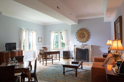 a living room with a couch and a fireplace at Wedmore Place in Williamsburg