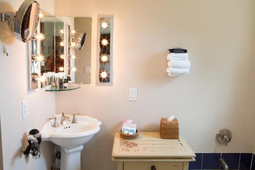 a white bathroom with a sink and a mirror at Wedmore Place in Williamsburg