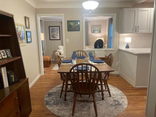 a kitchen and dining room with a table and chairs at Newly renovated 3-bedroom lakeside home in Euclid