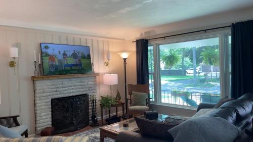 a living room with a couch and a fireplace at Newly renovated 3-bedroom lakeside home in Euclid