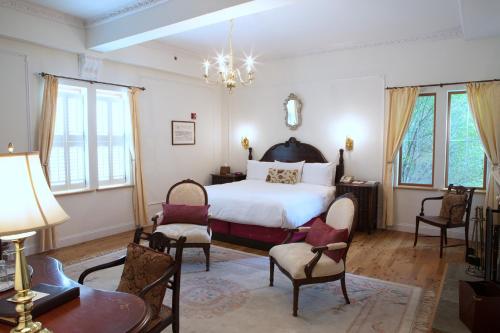 a bedroom with a bed and a table and chairs at Wedmore Place in Williamsburg