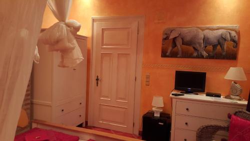 a room with a room with a door and a television at Edinburgh in Mariánské Lázně