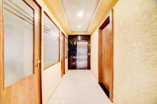 a corridor of a hallway with a door at Hotel O Ganpati in Bhopal