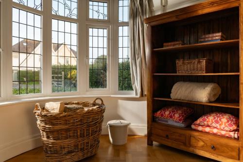 a room with a book shelf and windows at Summerfield in Conwy