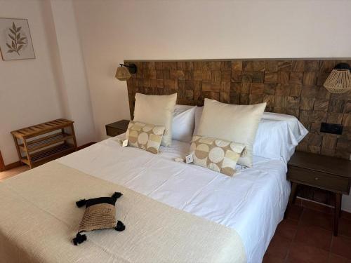 a bedroom with two beds and a cat on the floor at Casa Caldereta in Ayelo de Rugat