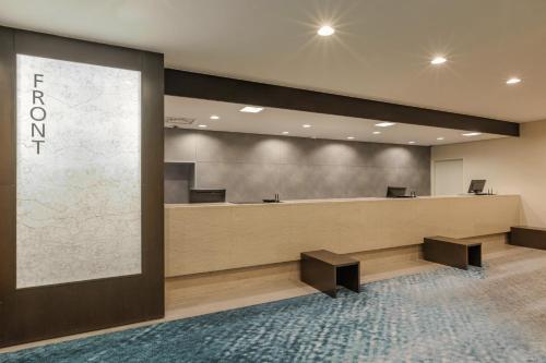 an office lobby with a reception desk and a large screen at Art Hotel Niigata Station in Niigata