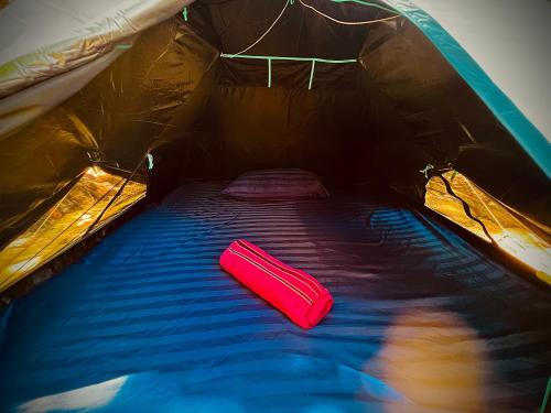a tent with a red sleeping bag in it at Bubble Paradise, Koh ta Kiev in Koh Ta kiev Island