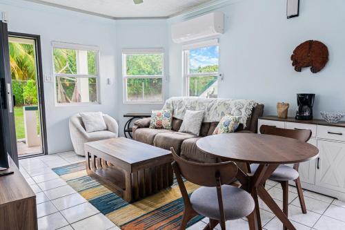 a living room with a couch and a table at Garden Apartment in Trinity