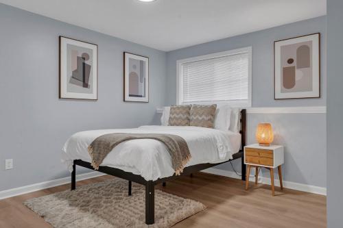a bedroom with a bed and a table with a lamp at The Boho Lux Haven Prov in Providence