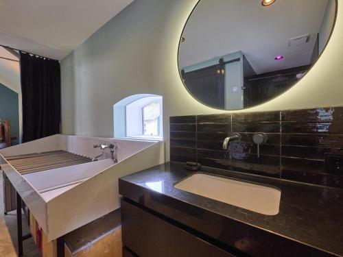 a bathroom with a sink and a mirror at The Green Getaway in Buurse