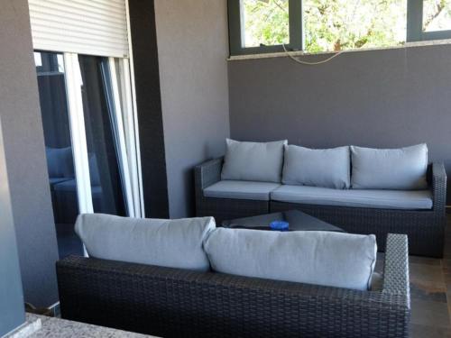 a living room with two couches and a couch at Apartments Ro Ma A1 in Novo Selo Požeško