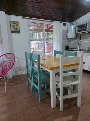 a kitchen with a wooden table and chairs at Quinta Los Sauces in San Miguel del Monte