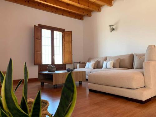 a living room with two couches and a table at Stone house with private pool in Agua Amarga in Los Cerrillos