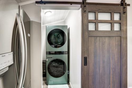 a washer and dryer in a room next to a door at Sip and Hike! Autumn Escape 12 Mi to Traverse City in Grawn