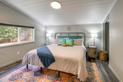 a bedroom with a bed and a window at Sip and Hike! Autumn Escape 12 Mi to Traverse City in Grawn