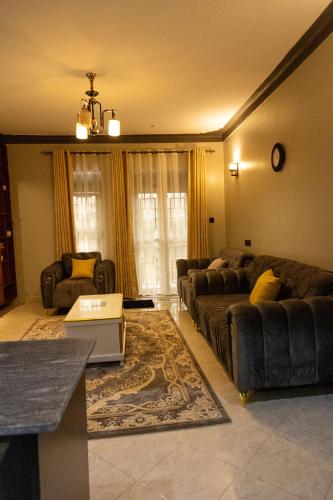 a living room with a couch and a table at JH Luxury Suites in Kampala