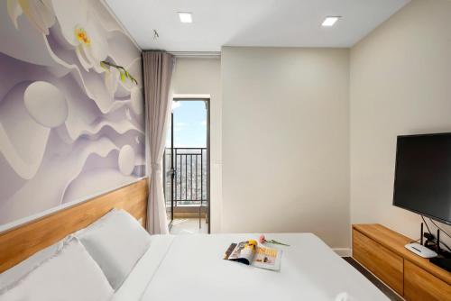 a bedroom with a bed and a flat screen tv at CBD Luxury Apartment in Rivergate Tower in Ho Chi Minh City