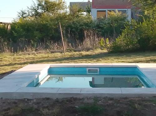 a swimming pool in a yard with a house at Casa WIWI in La Estancia