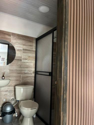 a bathroom with a toilet and a sink at K a p l a A l o j a m i e n t o in San Rafael