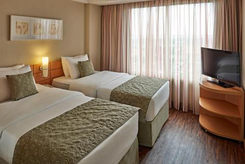 Кровать или кровати в номере Mercure Guarulhos Aeroporto