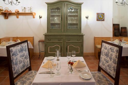 a dining room with a table and a green cabinet at Wedmore Place in Williamsburg