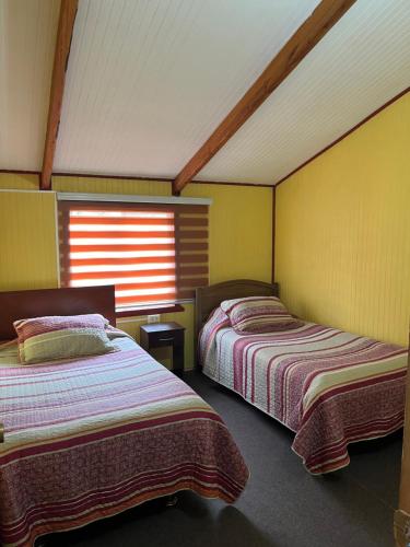 Postel nebo postele na pokoji v ubytování Cabañas el mañio