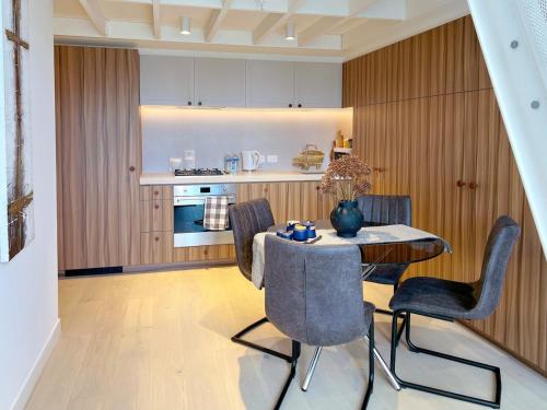a kitchen and dining room with a table and chairs at Convenient Loft Modern Stay Central Box Hill in Box Hill