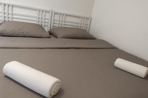 a bedroom with a bed with two pillows at Haus am Vogesenblick - Ihr Zimmer mit Aussicht in Bad Bellingen